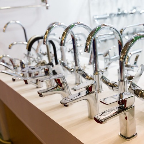 a row of stainless steel faucets