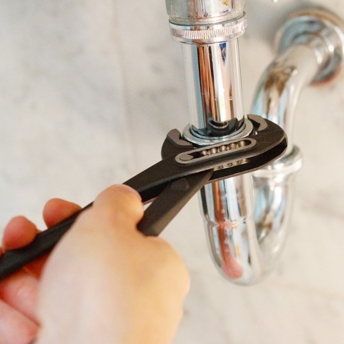 close-up of a pipe being adjusted