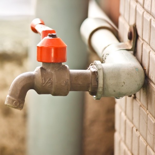 a faucet near a toilet