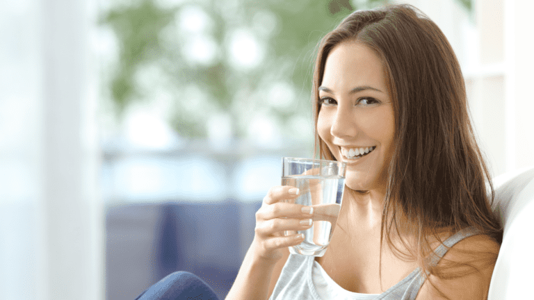 woman drinking clean water from a water filtration system